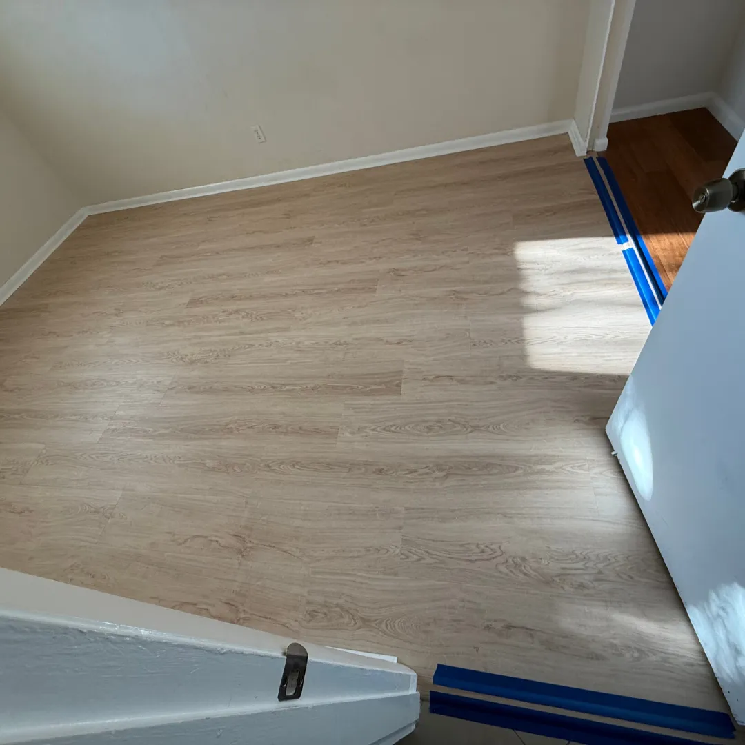 Light vinyl plank flooring installation in progress