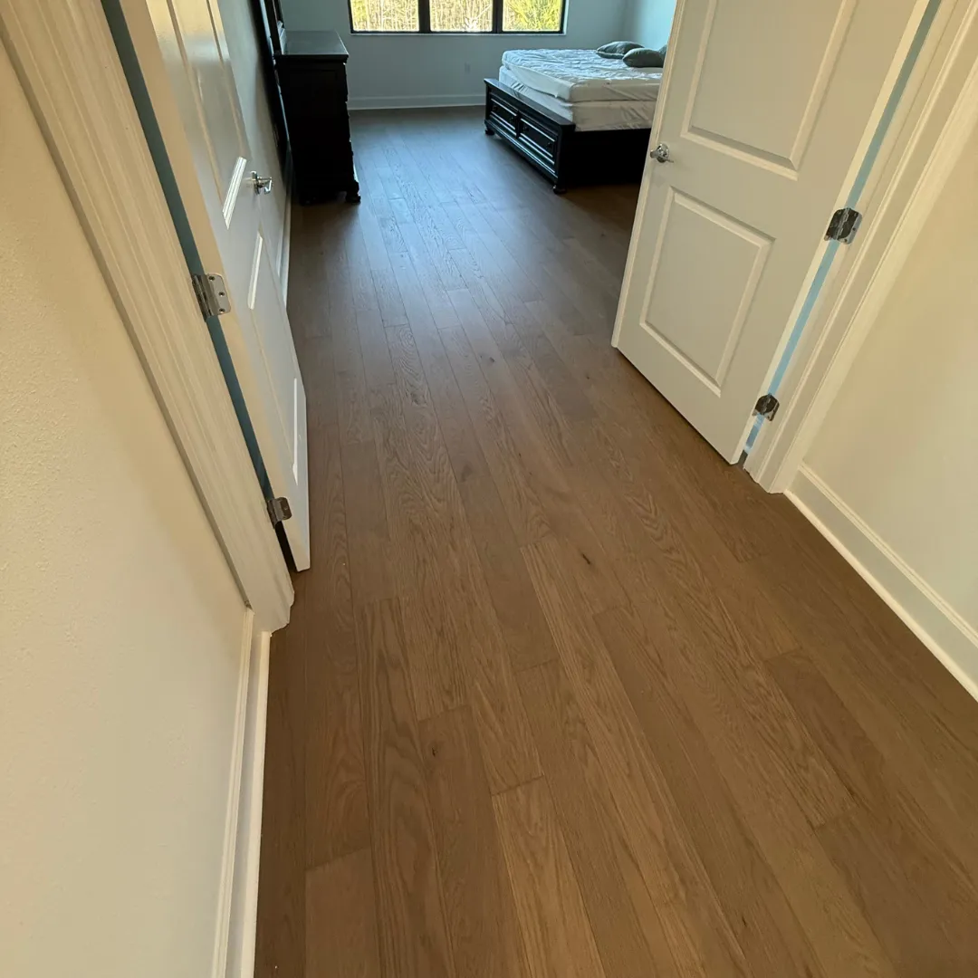 Red oak hardwood flooring installation in hallway and bedroom
