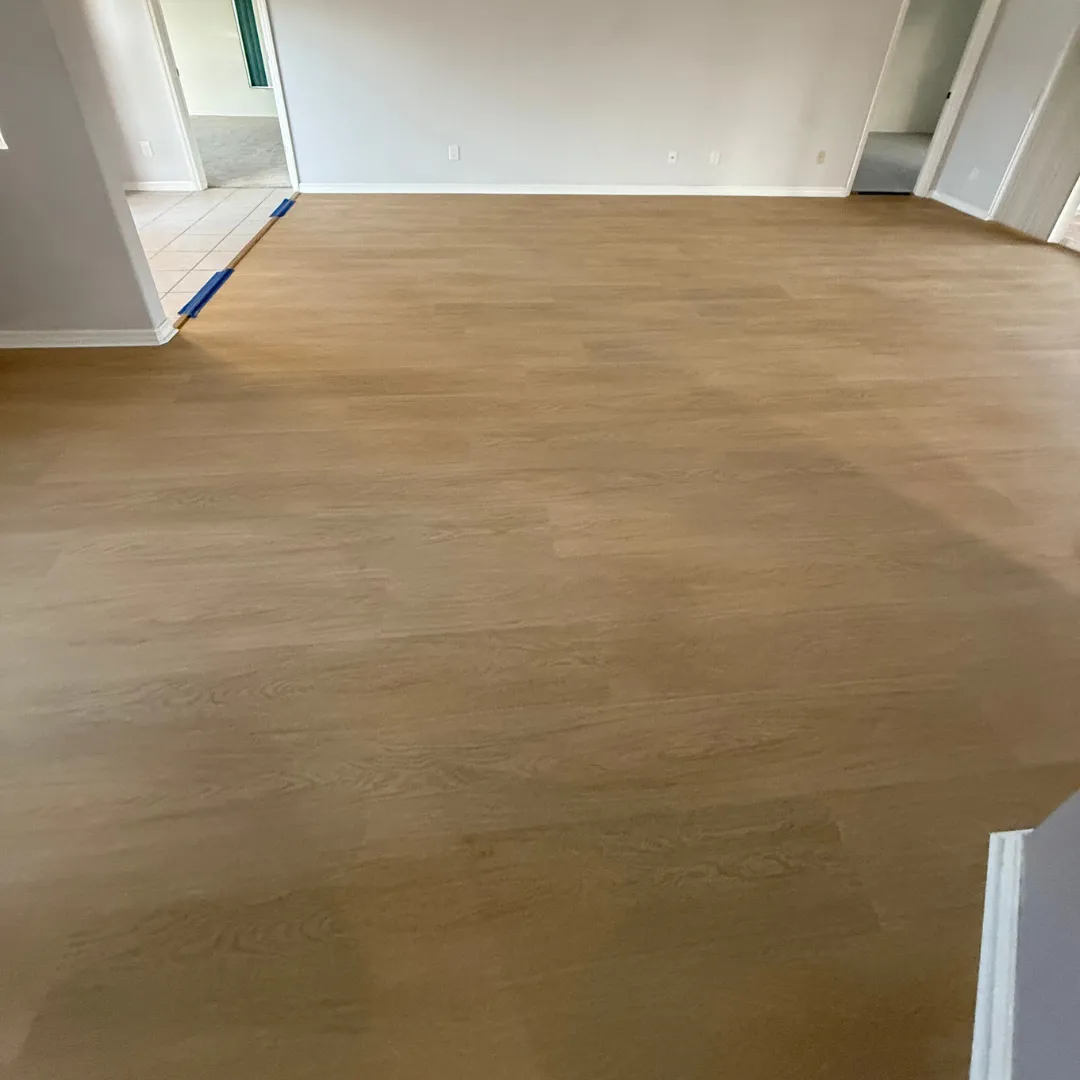 Smooth vinyl plank floor installation in open living area