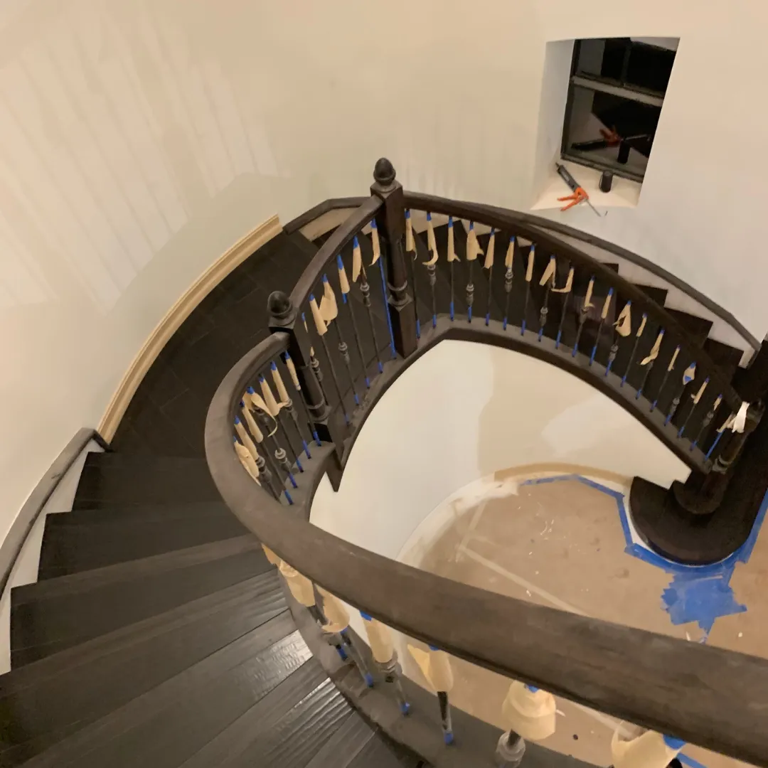 Dark wood spiral staircase with custom railing in Florida home