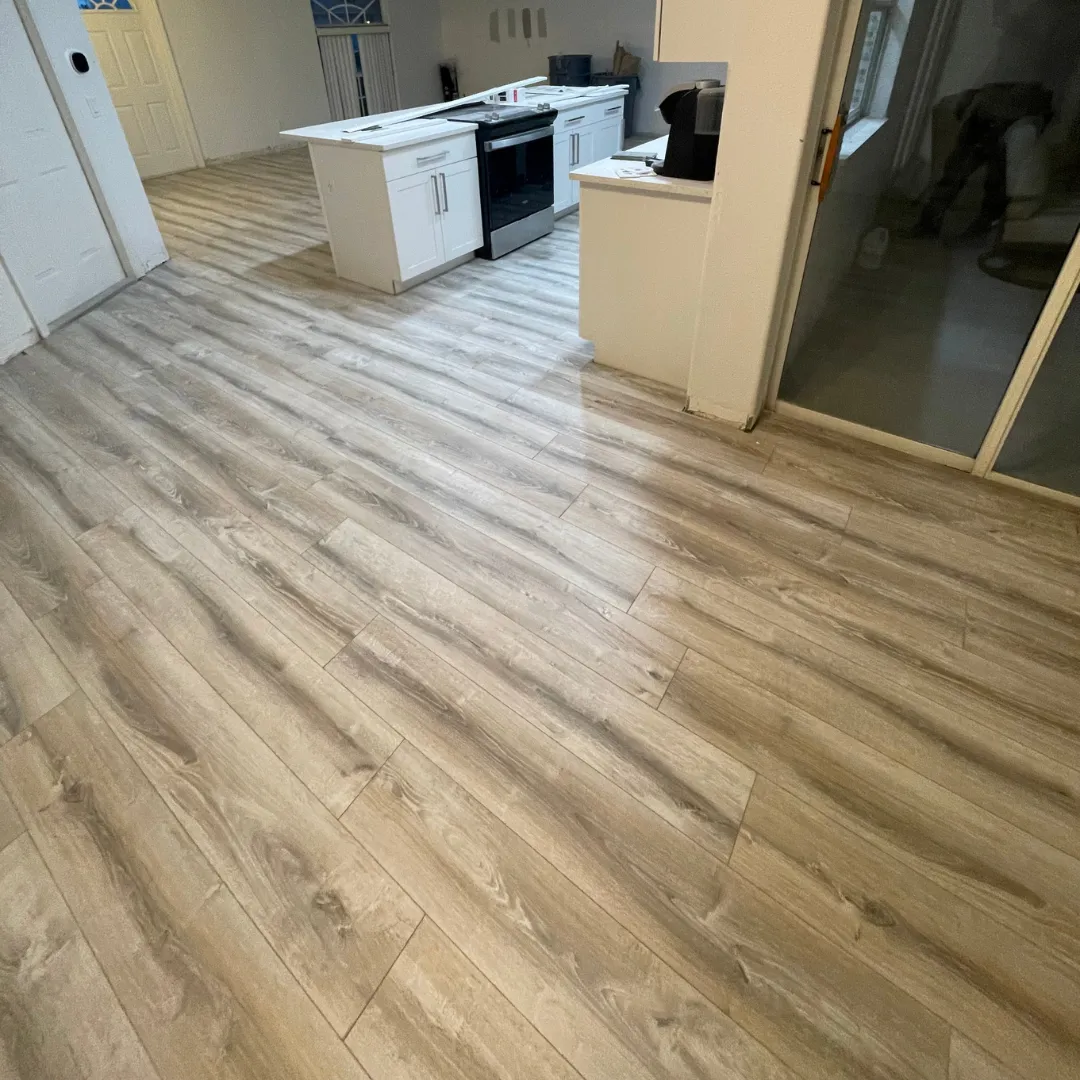 Distressed gray laminate flooring in updated kitchen