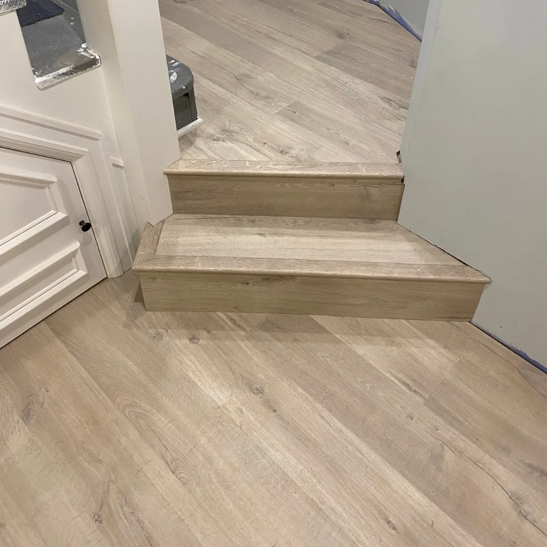 Light oak laminate flooring with matching split-level stair treads