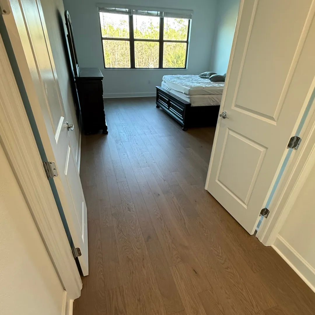 Wire-brushed oak hardwood floor installation in Cape Coral, FL bedroom