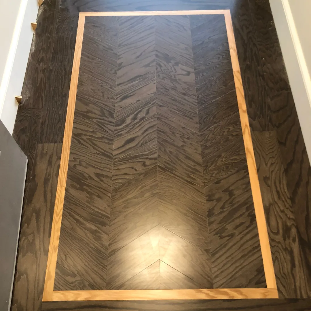 Custom chevron parquet hardwood floor inlay with contrasting border