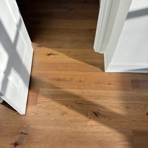 Rustic hickory hardwood flooring with natural sunlight